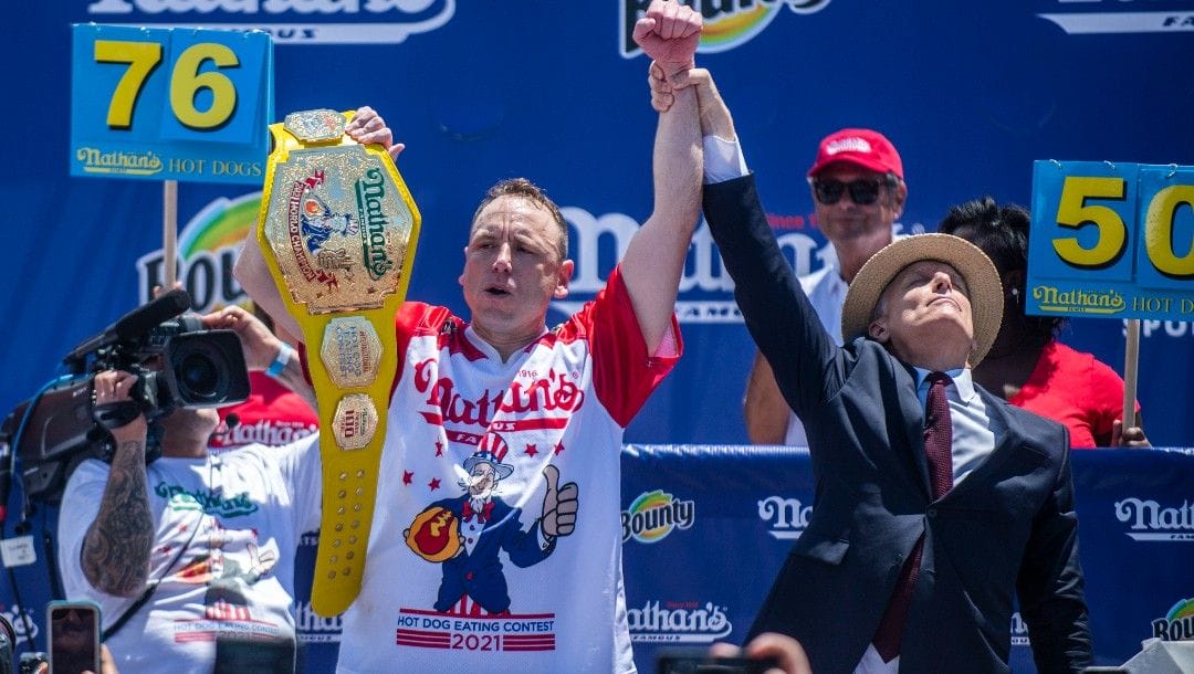 Chowdown champ Joey “Jaws” Chestnut celebrates after winning the the Nathan's Famous Fourth of July International Hot Dog-Eating Contest in Coney Island's Maimonides Park on Sunday, July 4, 2021, in the Brooklyn borough of New York.