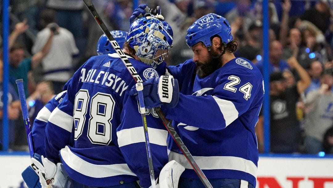 Tampa Bay Lightning goaltender Andrei Vasilevskiy (88) celebrates with defenseman Zach Bogosian (24) after the team defeated the New York Rangers during Game 4 of the NHL hockey Stanley Cup playoffs Eastern Conference finals Tuesday, June 7, 2022, in Tampa, Fla.