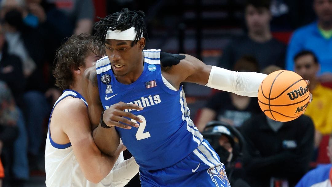 Memphis center Jalen Duren (2) drives past Boise State forward Tyson Degenhart, left, during the first half of a first round NCAA college basketball tournament game, Thursday, March 17, 2022, in Portland, Ore.