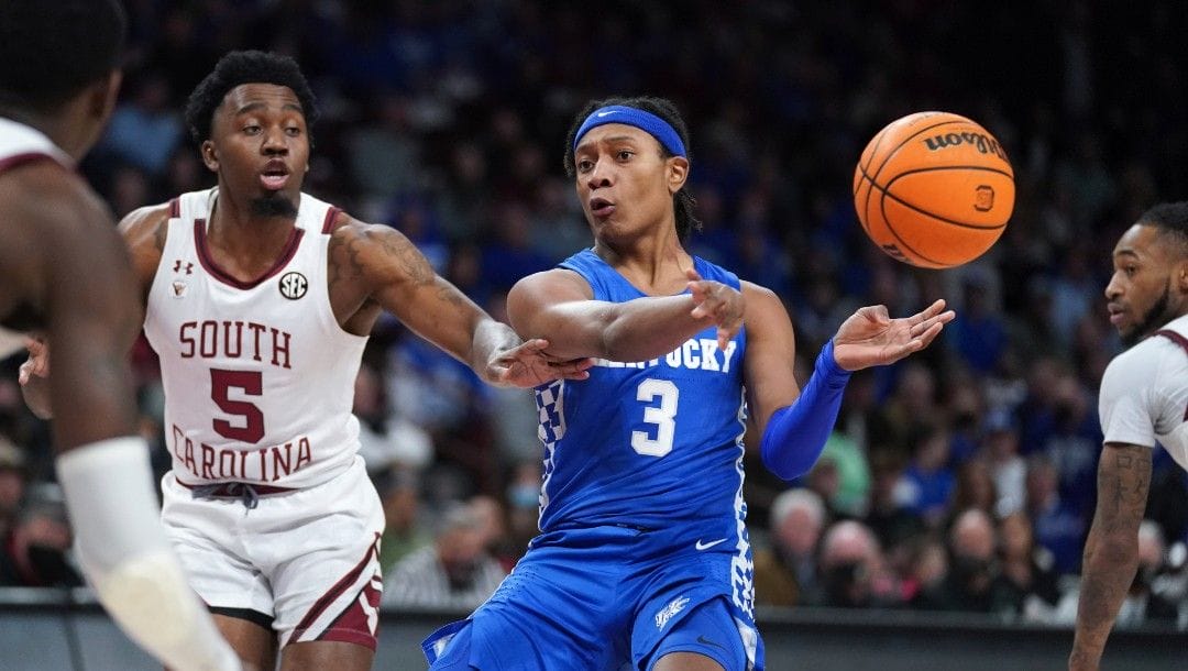 Kentucky guard TyTy Washington Jr. (3) passes the ball away from South Carolina guard Jermaine Couisnard (5) during the first half of an NCAA college basketball game Feb. 8, 2022, in Columbia, S.C.