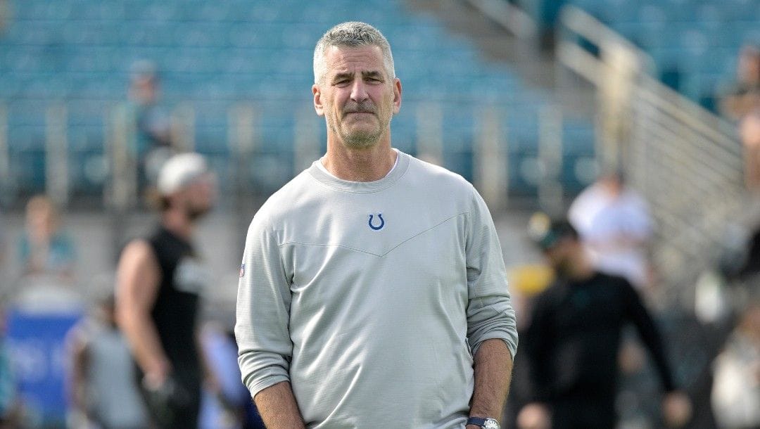 Indianapolis Colts head coach Frank Reich watches players warm up before an NFL football game against the Jacksonville Jaguars, Sunday, Jan. 9, 2022, in Jacksonville, Fla.