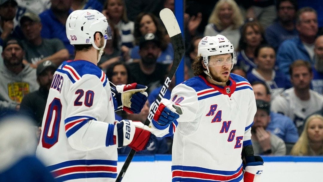 New York Rangers left wing Artemi Panarin (10) celebrates his goal against the Tampa Bay Lightning with left wing Chris Kreider (20) during the third period in Game 4 of the NHL hockey Stanley Cup playoffs Eastern Conference finals Tuesday, June 7, 2022, in Tampa, Fla.