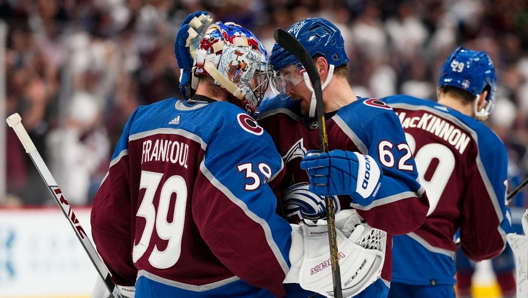 Colorado Avalanche left wing Artturi Lehkonen (62) celebrates the team's 4-0 win against the Edmonton Oilers with goaltender Pavel Francouz (39) following Game 2 of the NHL hockey Stanley Cup playoffs Western Conference finals Thursday, June 2, 2022, in Denver.