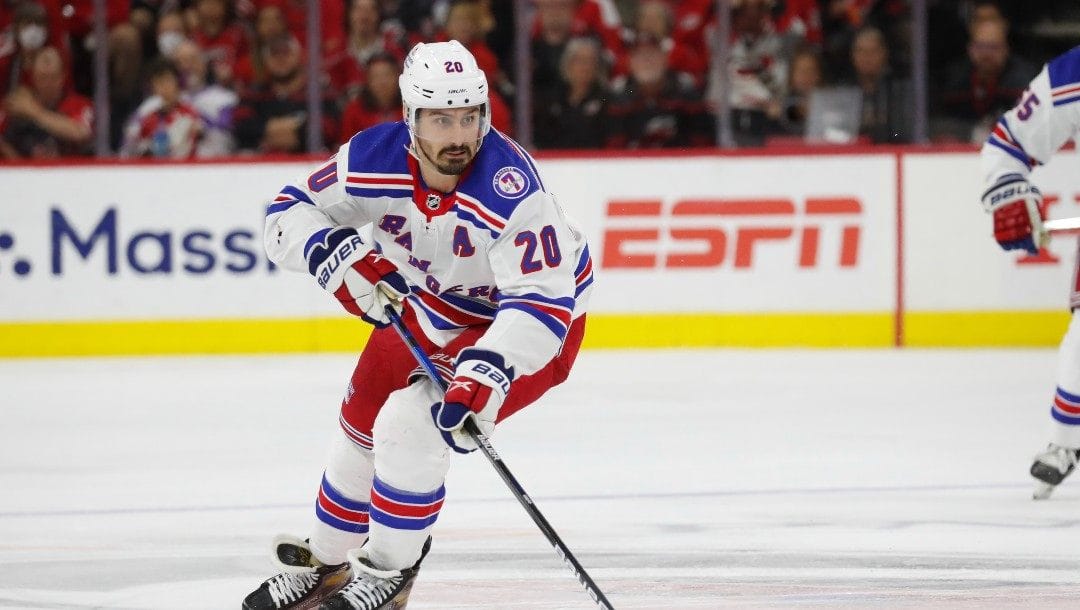 New York Rangers' Chris Kreider (20) skates with the puck against the Carolina Hurricanes during the third period of Game 5 of an NHL hockey Stanley Cup second-round playoff series in Raleigh, N.C., Thursday, May 26, 2022.