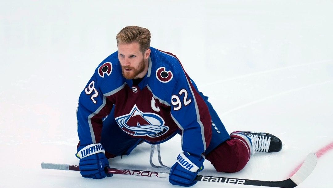 Colorado Avalanche left wing Gabriel Landeskog stretches before Game 2 of the team's NHL hockey Stanley Cup playoffs Western Conference finals against the Edmonton Oilers on Thursday, June 2, 2022, in Denver.