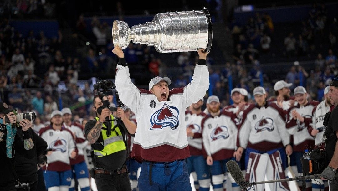Colorado Avalanche defenseman Jack Johnson lifts the Stanley Cup after the team defeated the Tampa Bay Lightning in Game 6 of the NHL hockey Stanley Cup Finals on Sunday, June 26, 2022, in Tampa, Fla.