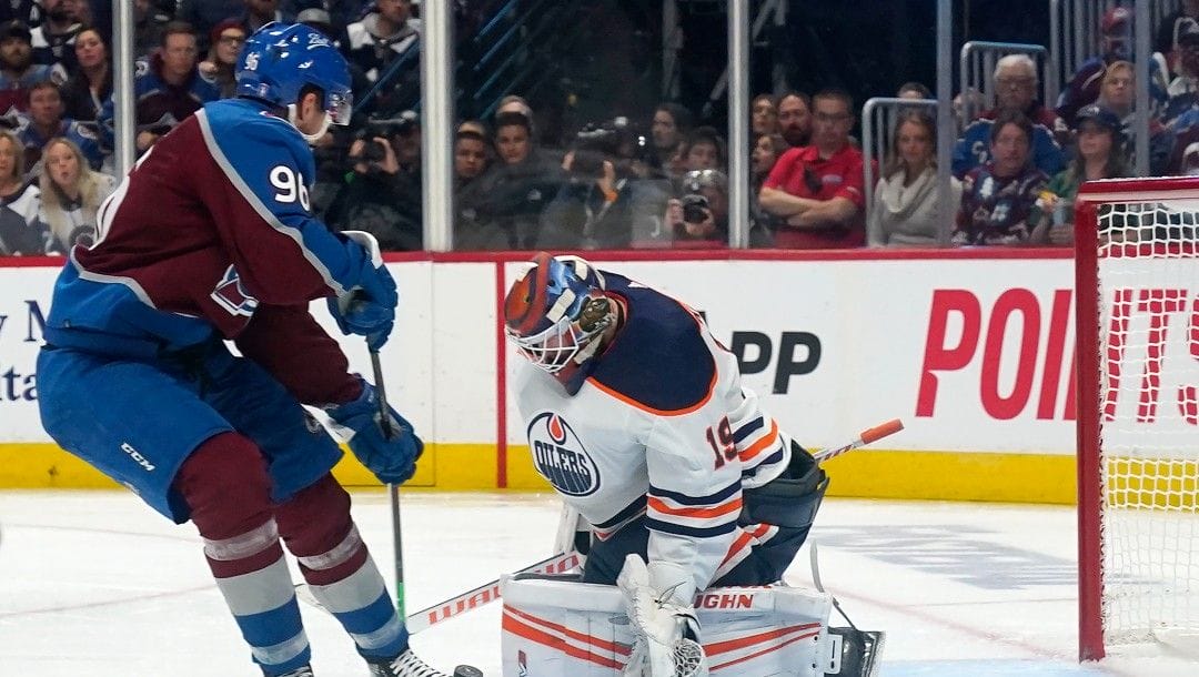 Edmonton Oilers goaltender Mikko Koskinen (19) makes a save against Colorado Avalanche right wing Mikko Rantanen (96) during the third period in Game 1 of the NHL hockey Stanley Cup playoffs Western Conference finals Tuesday, May 31, 2022, in Denver.