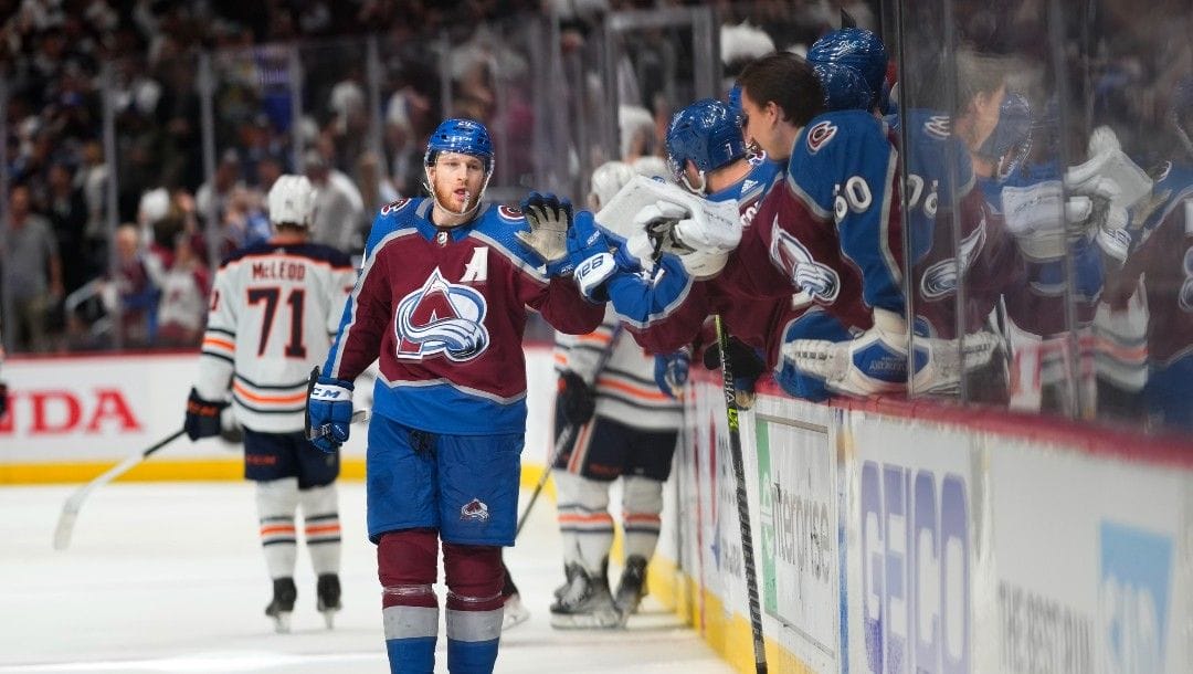Colorado Avalanche center Nathan MacKinnon (29) is congratulated for his goal against the Edmonton Oilers during the third period in Game 2 of the NHL hockey Stanley Cup playoffs Western Conference finals Thursday, June 2, 2022, in Denver.