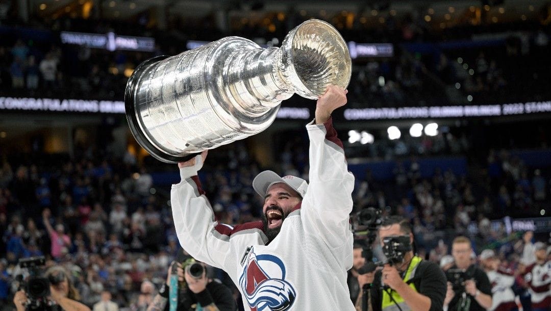 Colorado Avalanche center Nazem Kadri lifts the Stanley Cup after the team defeated the Tampa Bay Lightning in Game 6 of the NHL hockey Stanley Cup Finals on Sunday, June 26, 2022, in Tampa, Fla.