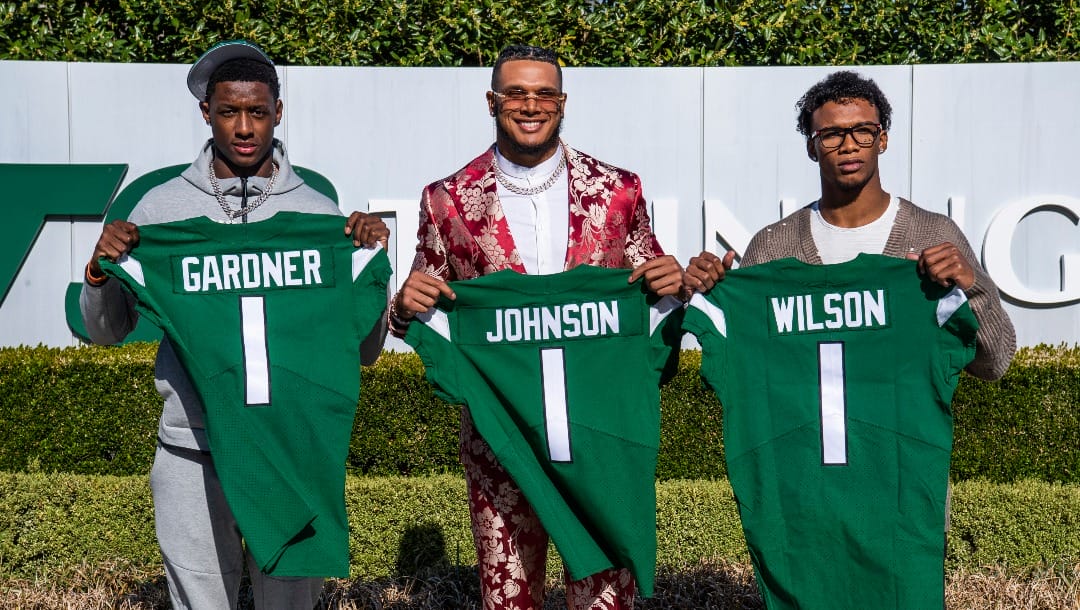 From left to right, Ahmad Gardner, Jermaine Johnson and Garrett Wilson pose for a portrait while holding New York Jets jerseys Friday, April 29, 2022, in Florham Park, N.J. (AP Photo/Brittainy Newman)