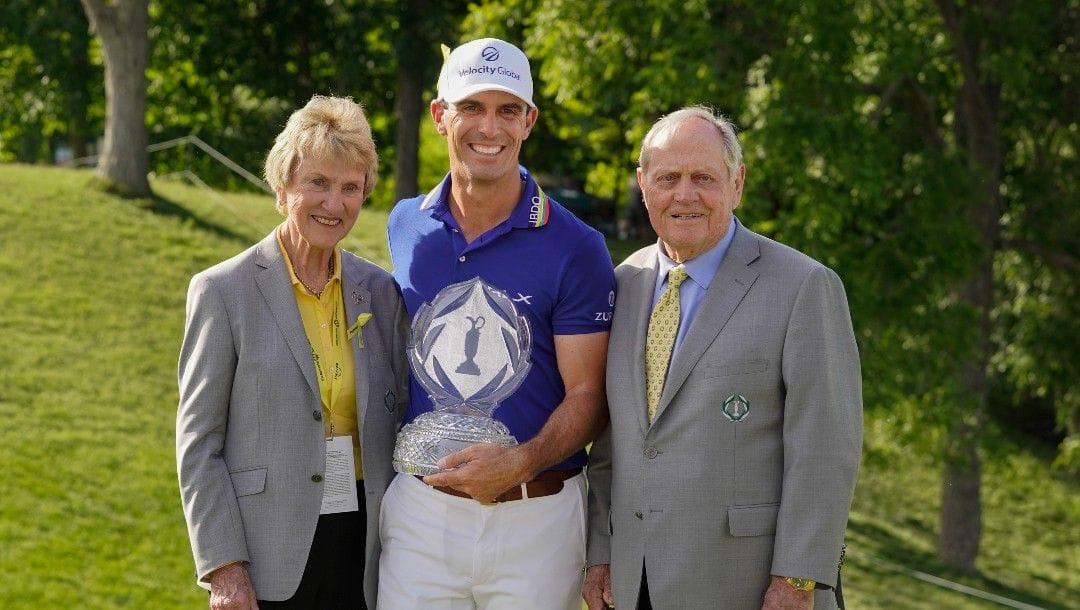 Billy Horschel, center, poses with Jack and Barbara Nicklaus after Horschel won the Memorial golf tournament Sunday, June 5, 2022, in Dublin, Ohio.