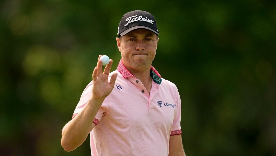 Justin Thomas waves after making a putt on the 14th hole during the final round of the PGA Championship golf tournament at Southern Hills Country Club, Sunday, May 22, 2022, in Tulsa, Okla.
