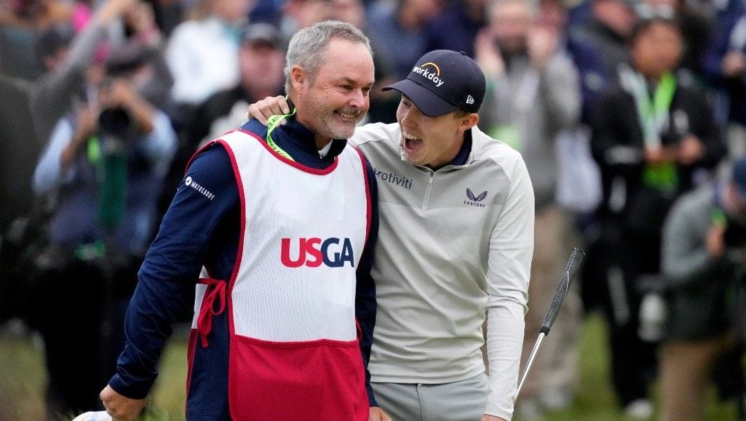 Matthew Fitzpatrick, of England, celebrates with his caddie after winning the U.S. Open golf tournament at The Country Club, Sunday, June 19, 2022, in Brookline, Mass.