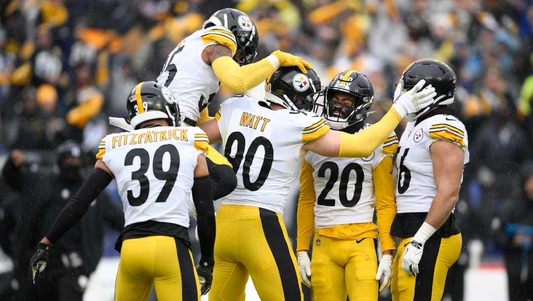 Pittsburgh Steelers outside linebacker T.J. Watt (90) celebrates with teammates, from left, free safety Minkah Fitzpatrick (39), cornerback Arthur Maulet (35), cornerback Cameron Sutton (20) and outside linebacker Alex Highsmith (56) after recording a forced fumble against Baltimore Ravens quarterback Tyler Huntley during the first half of an NFL football game, Sunday, Jan. 9, 2022, in Baltimore.