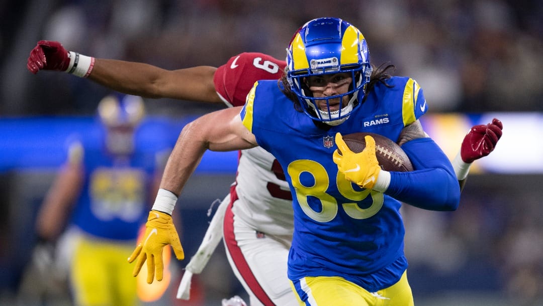 Los Angeles Rams tight end Tyler Higbee (89) runs with the ball as Arizona Cardinals inside linebacker Isaiah Simmons (9) chases him during an NFL wild-card playoff football game Monday, Jan. 17, 2022, in Inglewood, Calif. (AP Photo/Kyusung Gong)