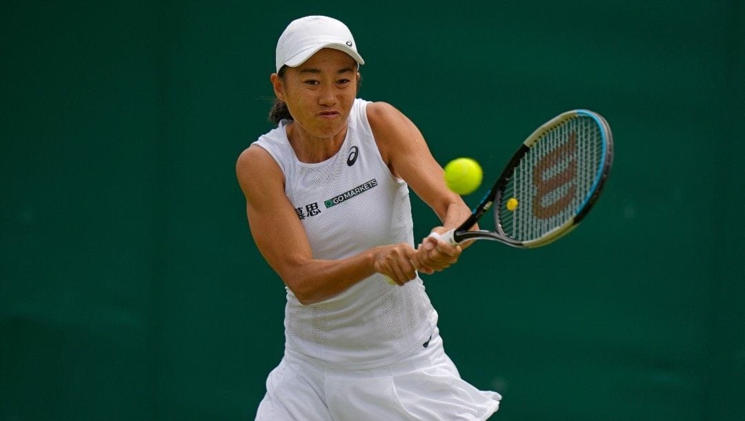 China's Shuai Zhang returns to Ukraine's Marta Kostyuk during a women's singles match on day three of the Wimbledon tennis championships in London, Wednesday, June 29, 2022.