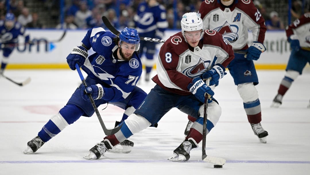 Colorado Avalanche defenseman Cale Makar (8) controls a puck in front of Tampa Bay Lightning center Anthony Cirelli (71) during the third period of Game 4 of the NHL hockey Stanley Cup Finals on Wednesday, June 22, 2022, in Tampa, Fla. (AP Photo/Phelan M. Ebenhack)