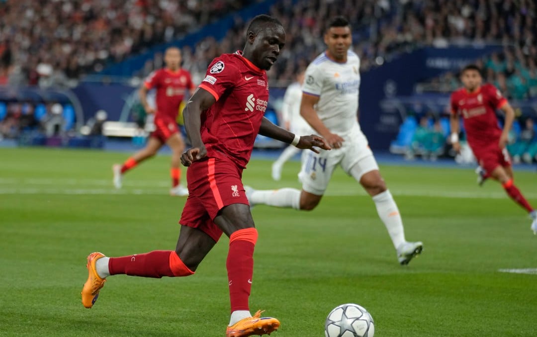Liverpool's Sadio Mane passes the ball during the Champions League final soccer match between Liverpool and Real Madrid at the Stade de France in Saint Denis near Paris, Saturday, May 28, 2022.