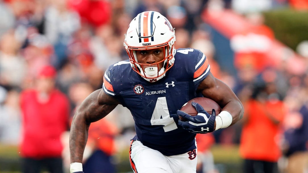 Auburn running back Tank Bigsby (4) carries the ball against Alabama during the first half of an NCAA college football game Saturday, Nov. 27, 2021, in Auburn, Ala. (AP Photo/Butch Dill)