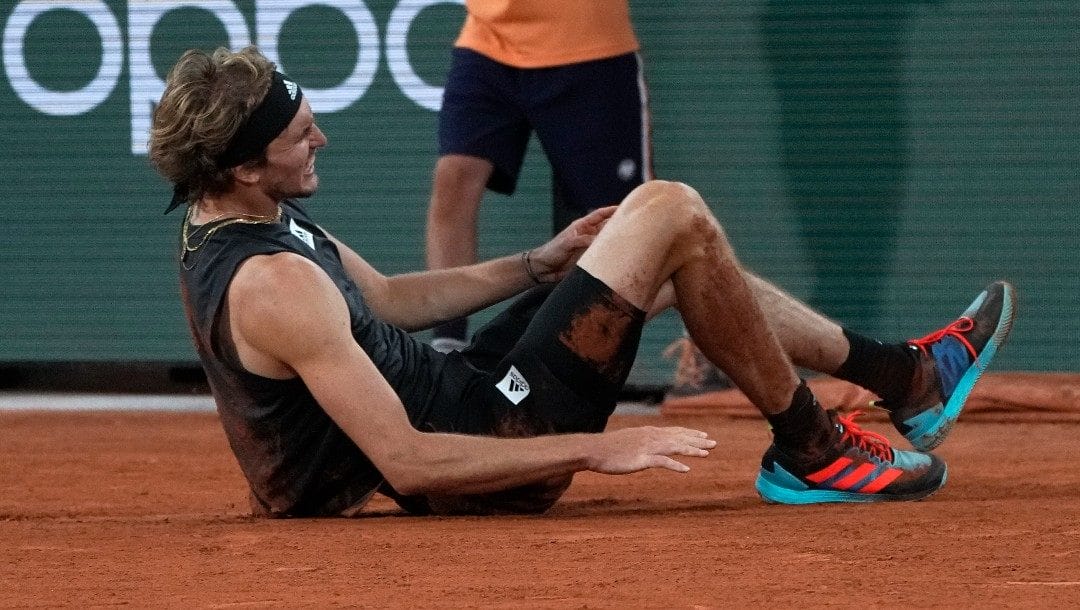 Germany's Alexander Zverev grimaces in pain after falling as he plays Spain's Rafael Nadal, during their semifinal match of the French Open tennis tournament at the Roland Garros stadium Friday, June 3, 2022 in Paris. Zverev withdrew from the match.