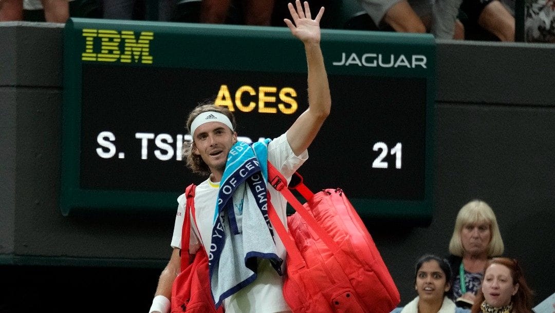 Greece's Stefanos Tsitsipas waves to the crowd after losing to Australia's Nick Kyrgios during their third round men's singles match on day six of the Wimbledon tennis championships in London, Saturday, July 2, 2022.