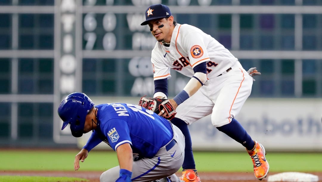 Houston Astros shortstop Mauricio Dubon, right, makes the tag for the out on Kansas City Royals runner Whit Merrifield, left, during the third inning of a baseball game Thursday, July 7, 2022, in Houston. (AP Photo/Michael Wyke)