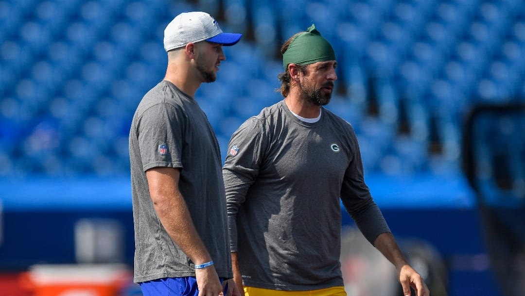 Green Bay Packers quarterback Aaron Rodgers, right, talks with Buffalo Bills quarterback Josh Allen before a preseason NFL football game in Orchard Park, N.Y., Saturday, Aug. 28, 2021.