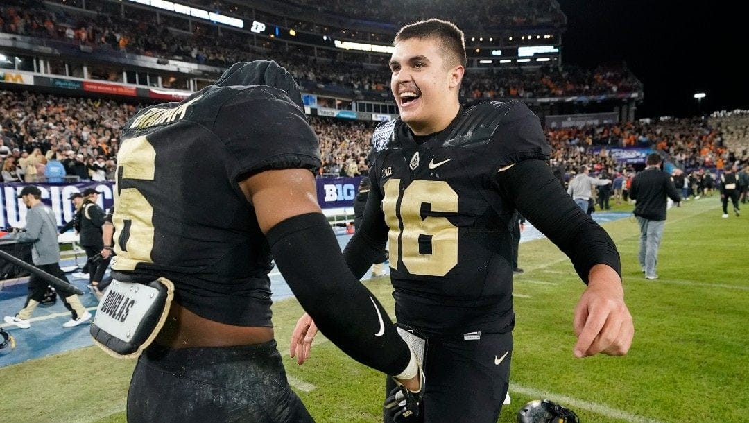 Purdue quarterback Aidan O'Connell (16) celebrates with linebacker Jalen Graham (6) after Purdue beat Tennessee in overtime in the Music City Bowl NCAA college football game Thursday, Dec. 30, 2021, in Nashville, Tenn. Purdue won 48-45.