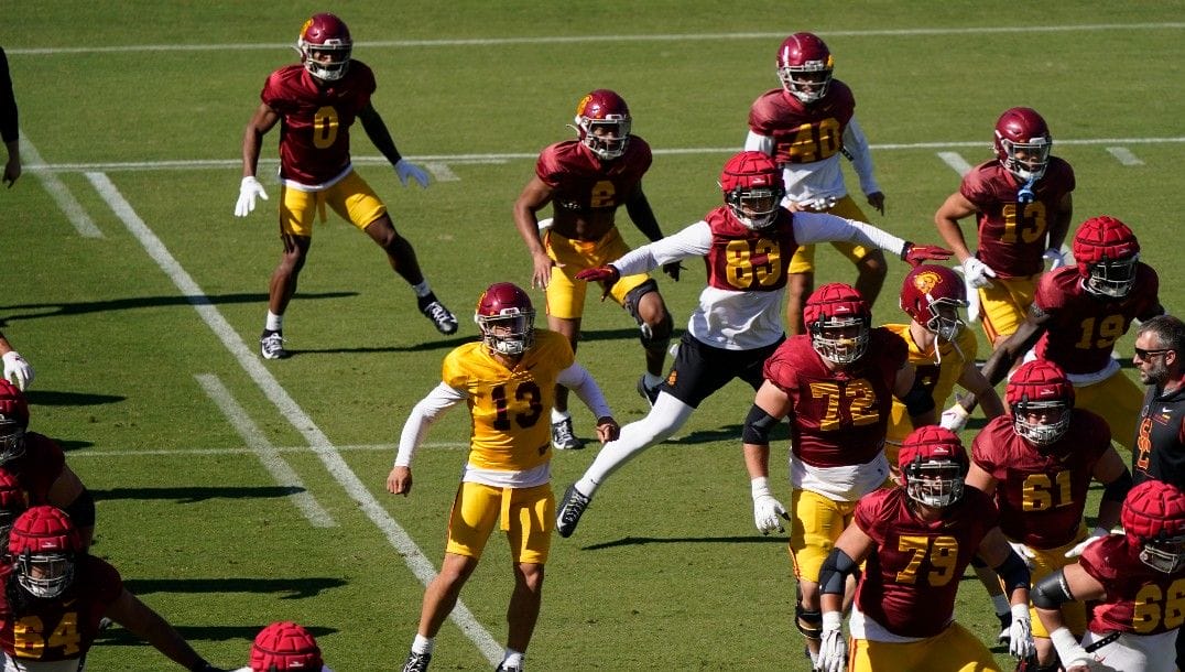 Southern California quarterback Caleb Williams (13) goes through running drills during an NCAA college football practice Tuesday, April 12, 2022, in Los Angeles.
