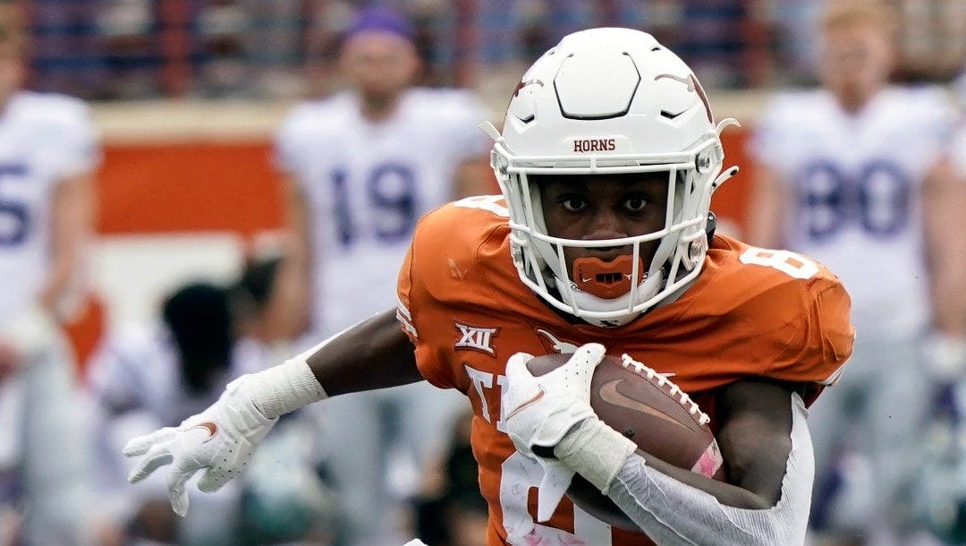 Texas' Xavier Worthy (8) runs with ball against Kansas State during the first half of an NCAA college football game in Austin, Texas, Nov. 26, 2021.