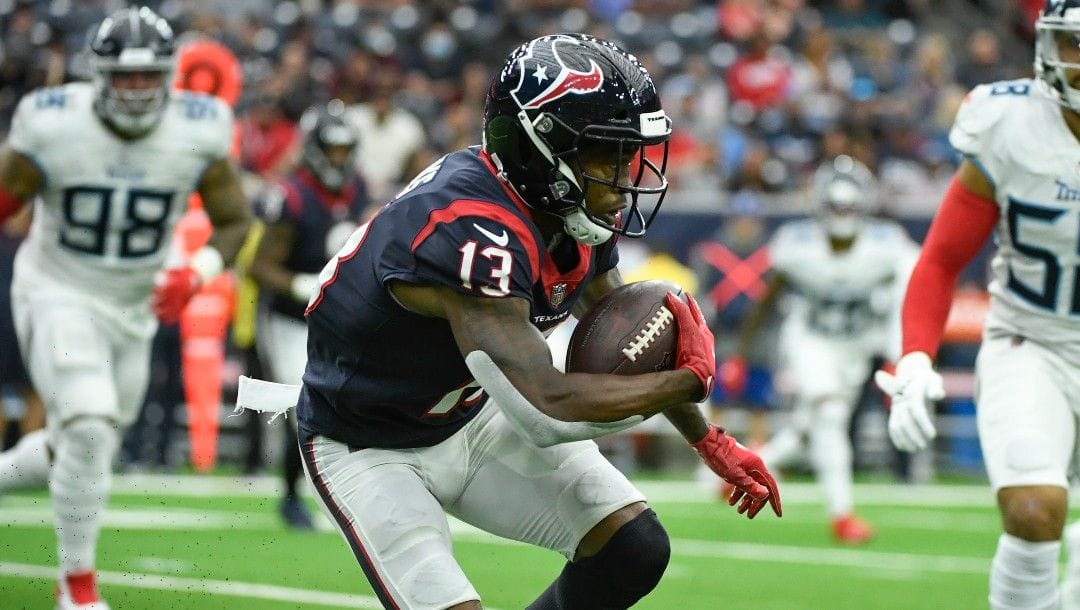 Houston Texans wide receiver Brandin Cooks (13) runs with the ball against the Tennessee Titans during the first half of an NFL football game Sunday, Jan. 9, 2022, in Houston.
