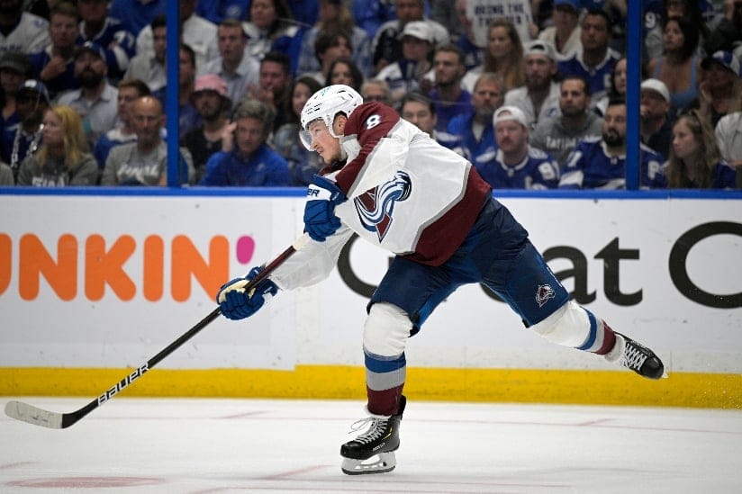 Colorado Avalanche defenseman Cale Makar (8) passes a puck during the third period of Game 6 of the NHL hockey Stanley Cup Finals against the Tampa Bay Lightning on Sunday, June 26, 2022, in Tampa, Fla.