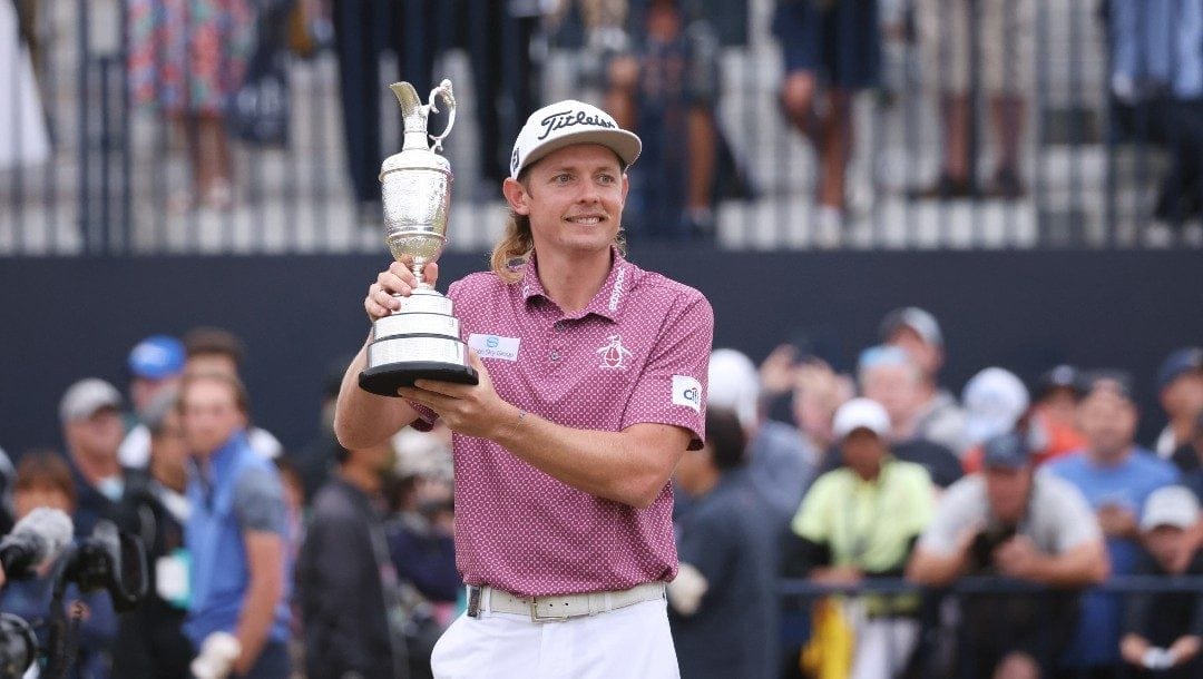 Cameron Smith, of Australia, holds the claret jug trophy as he poses for photographers on the 18th green after winning the British Open golf Championship on the Old Course at St. Andrews, Scotland, Sunday July 17, 2022.