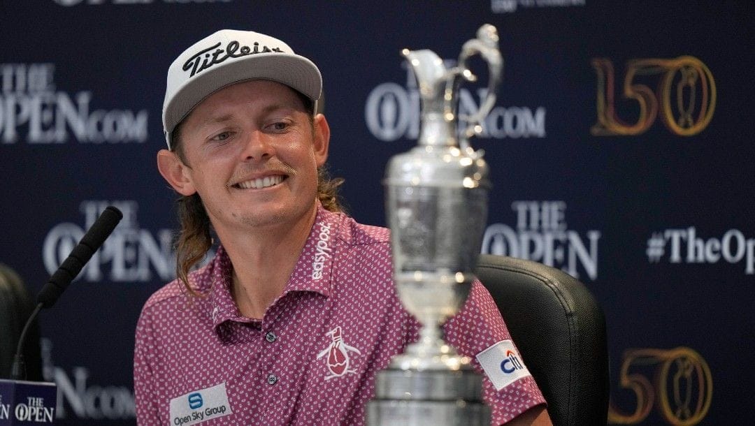 Cameron Smith, of Australia, looks at the claret jug trophy during a press conference after winning the British Open golf championship on the Old Course at St. Andrews, Scotland, Sunday July 17, 2022.