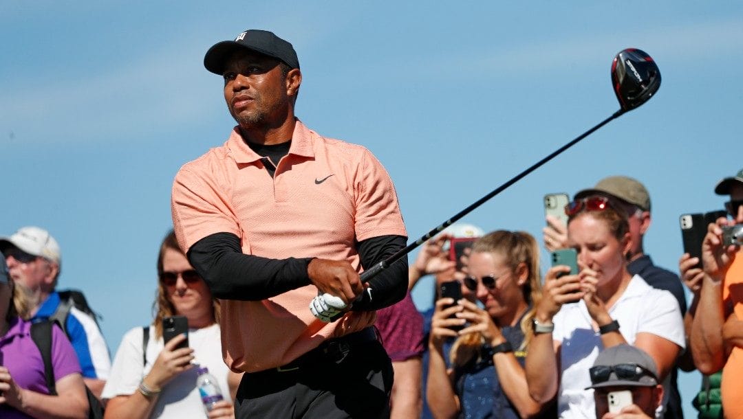 U.S golfer Tiger Woods tees off on the 9th hole during a practice round at the British Open golf championship on the Old Course at St. Andrews, Scotland, Sunday July 10, 2022