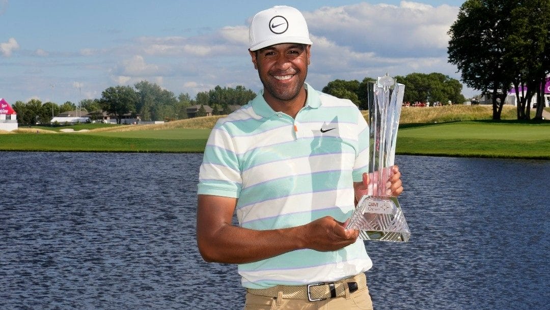 Tony Finau poses for photos with the trophy after his win in the 3M Open golf tournament at the Tournament Players Club in Blaine, Minn., Sunday, July 24, 2022.