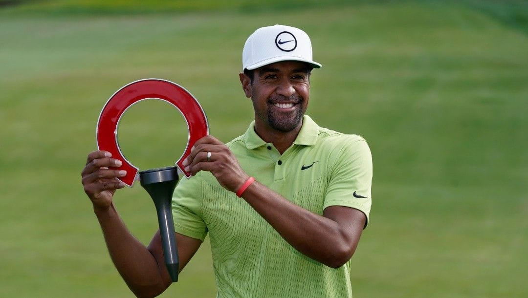 Tony Finau holds the winner's trophy after the final round of the Rocket Mortgage Classic golf tournament, Sunday, July 31, 2022, in Detroit.