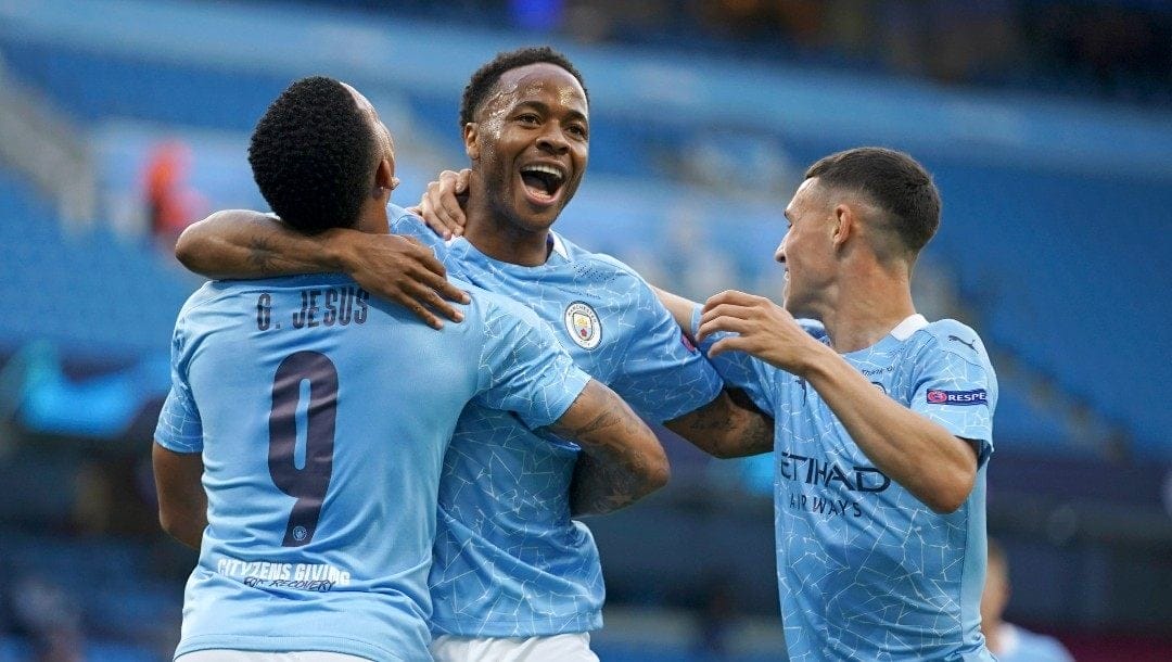Manchester City's Raheem Sterling, center, celebrates after scoring the opening goal during the Champions League round of 16, second leg soccer match between Manchester City and Real Madrid at the Etihad Stadium in Manchester, England, Friday, Aug. 7, 2020.