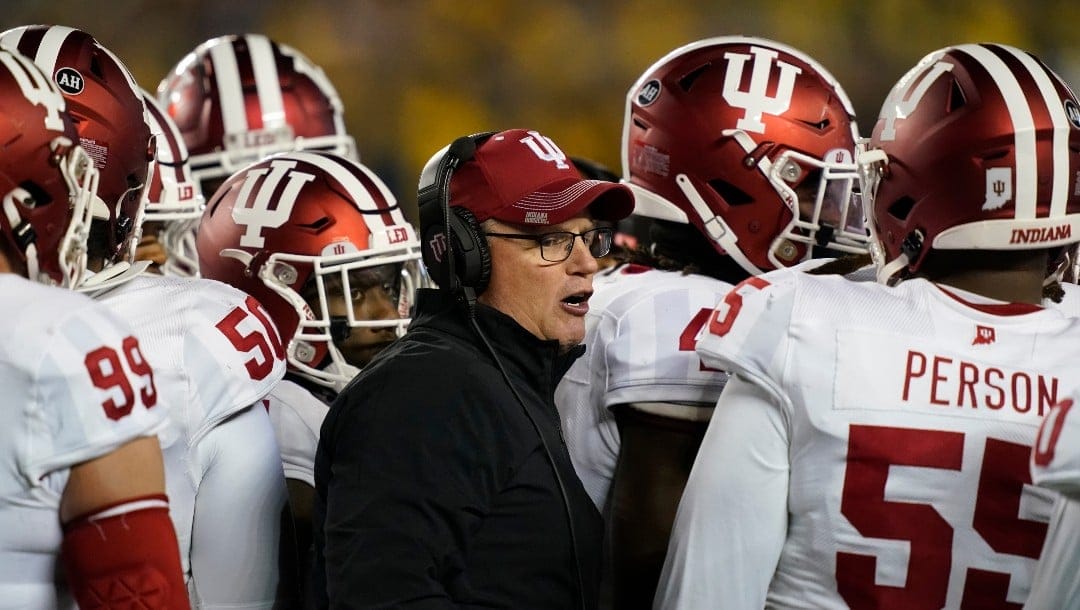 Indiana head coach Tom Allen stands next to his team during the first half of an NCAA college football game against Michigan, Saturday, Nov. 6, 2021, in Ann Arbor, Mich. (