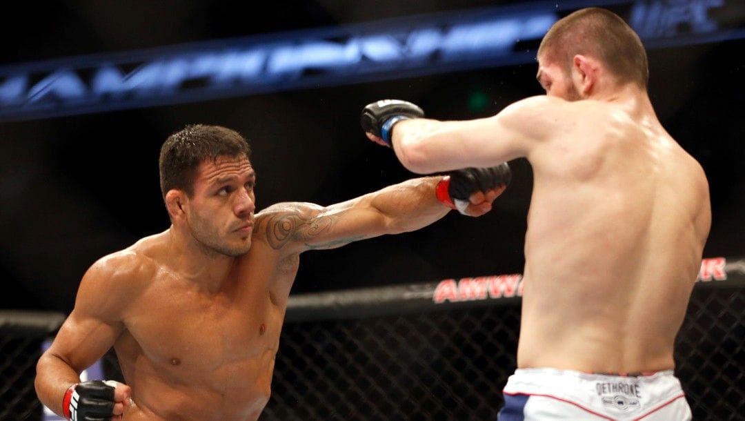Rafael dos Anjos from Brazil, left, and Khabib Nurmagomedov from Russia fight in a mixed martial arts event on Saturday, April 19, 2014, at UFC Fight Night in Orlando Fla.. Nurmagomedov won.