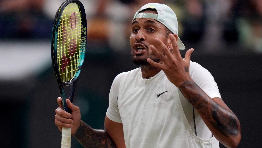 Australia's Nick Kyrgios reacts during his third round men's singles match against Greece's Stefanos Tsitsipas on day six of the Wimbledon tennis championships in London, Saturday, July 2, 2022.