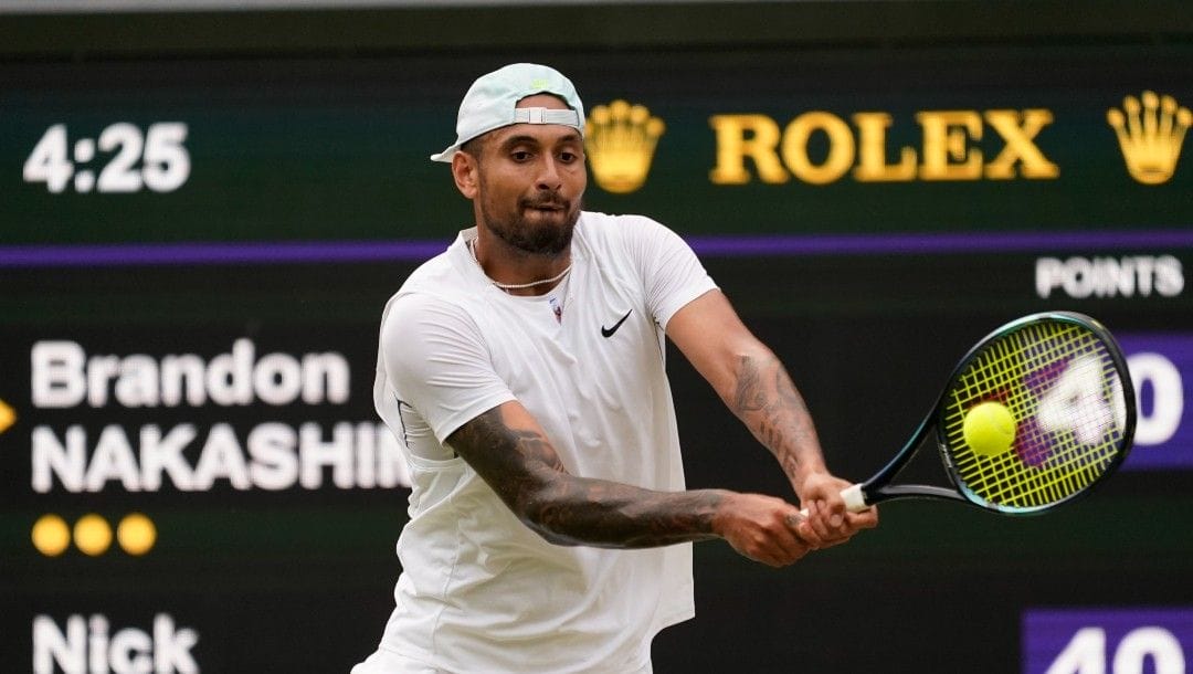Australia's Nick Kyrgios returns to Brandon Nakashima of the US in a men's singles fourth round match on day eight of the Wimbledon tennis championships in London, Monday, July 4, 2022.