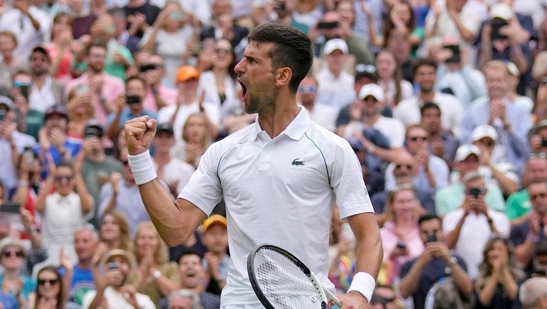Serbia's Novak Djokovic celebrates after beating Italy's Jannik Sinner in a men's singles quarterfinal match on day nine of the Wimbledon tennis championships in London, Tuesday, July 5, 2022.