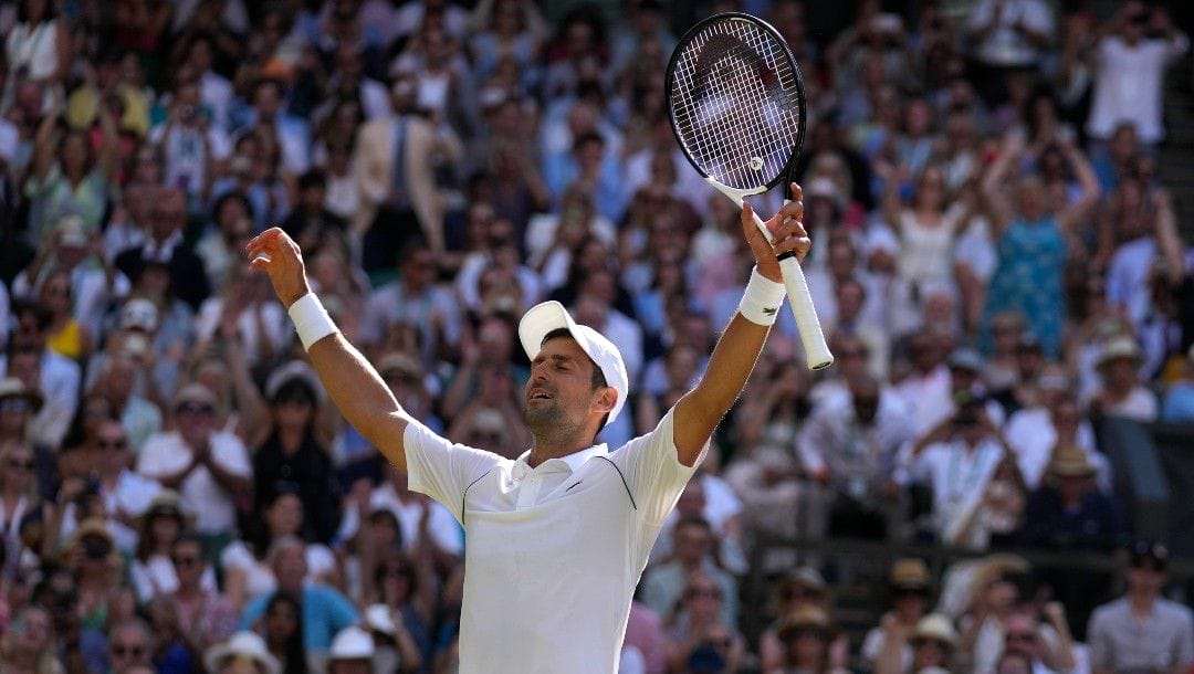 Serbia's Novak Djokovic celebrates after beating Australia's Nick Kyrgios to win the final of the men's singles on day fourteen of the Wimbledon tennis championships in London, Sunday, July 10, 2022.