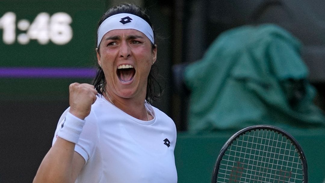 Tunisia's Ons Jabeur celebrates after winning a point against Marie Bouzkova of the Czech Republic in a women's singles quarterfinal match on day nine of the Wimbledon tennis championships in London, Tuesday, July 5, 2022.