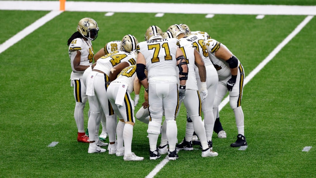 New Orleans Saints running back Alvin Kamara (41) and the New Orleans Saints huddle up during an NFL football game against the Minnesota Vikings, Friday, Dec. 25, 2020, in New Orleans.
