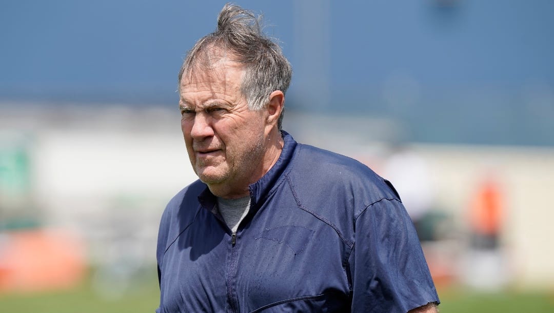 New England Patriots head coach Bill Belichick approaches a news conference to face reporters before an NFL football team practice, Tuesday, June 7, 2022, in Foxborough, Mass. (AP Photo/Steven Senne)