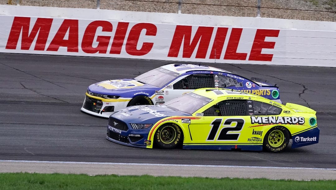 Ryan Blaney (12) and Chase Elliott drive side by side at a NASCAR Cup Series auto race, Sunday, July 18, 2021, in Loudon, N.H. (AP Photo/Charles Krupa)