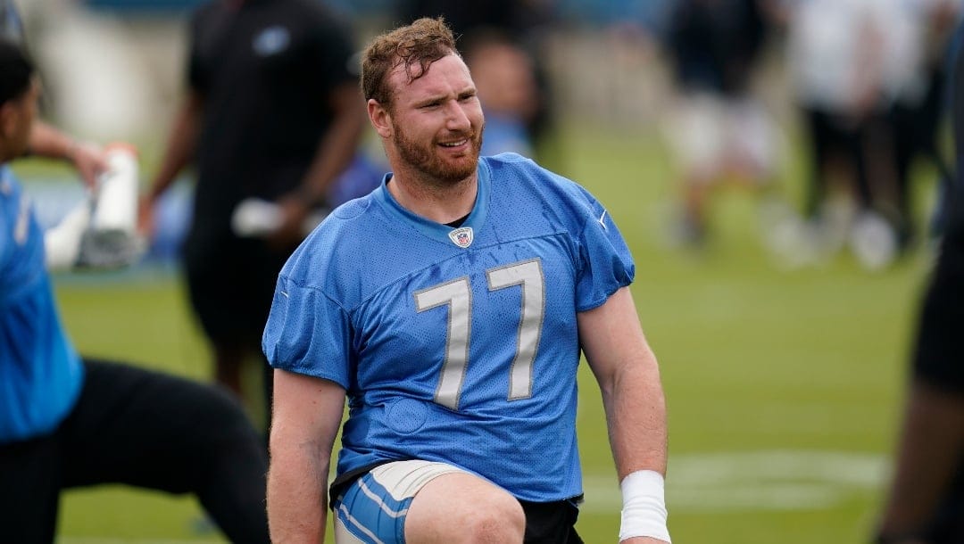 Detroit Lions center Frank Ragnow stretches during an NFL football practice in Allen Park, Mich., Thursday, May 26, 2022. (AP Photo/Paul Sancya)
