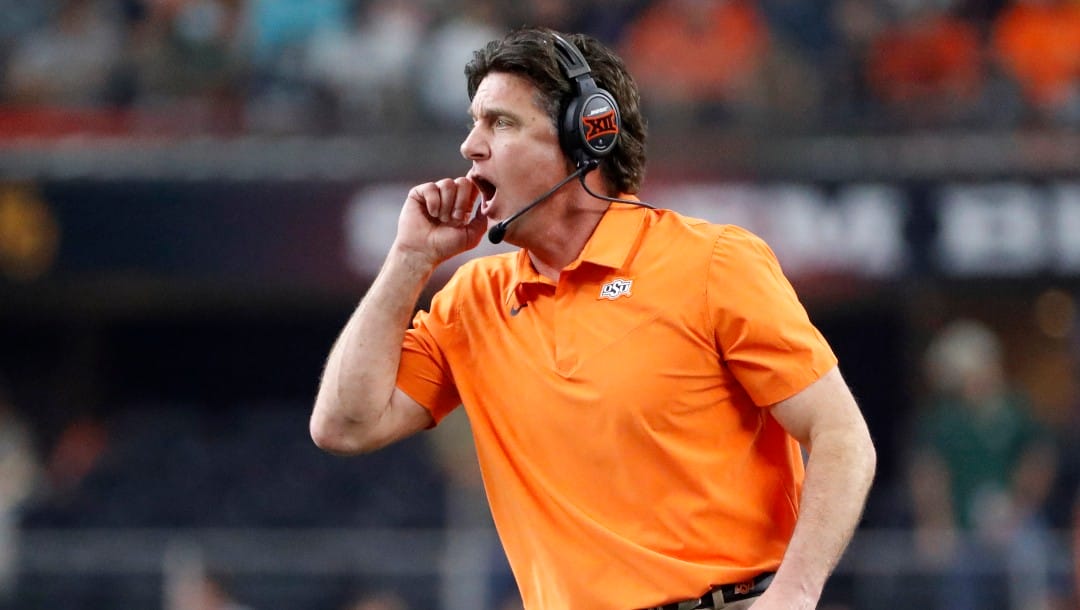 Oklahoma State head coach Mike Gundy watches play from the sideline during the first half of the Big 12 Championship NCAA college football game against Baylor in Arlington, Texas, Saturday, Dec. 4, 2021.